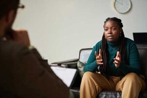 a client talks to a therapist in a dialectical behavior therapy program
