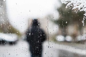 a person walks outside on a gray day, potentially trying to work on overcoming seasonal depression