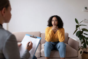 a client talks to a therapist in a cognitive-behavioral therapy program