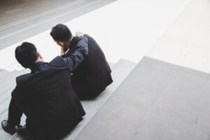 a person comforts another after recognizing signs of depression in a friend