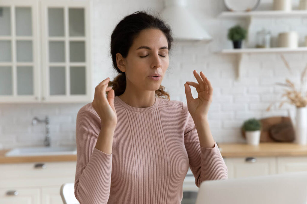 a person practices breath work after learning how to manage anxiety