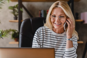 a woman talks on the phone while enjoying the benefits of virtual iop