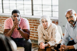 a therapy group for alcohol addiction treatment meets for a session