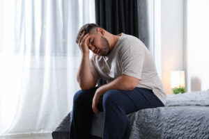 Man with hand on forehead
