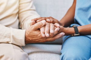 Nurse holding hands with patient
