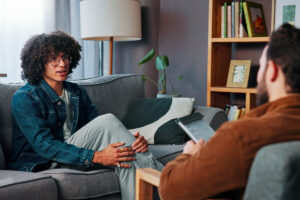Man speaking to therapist while sitting on couch