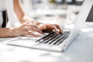 Close up of employee typing on keyboard at work