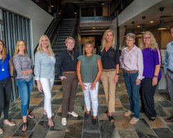 nine people on the Sophros Recovery team smile